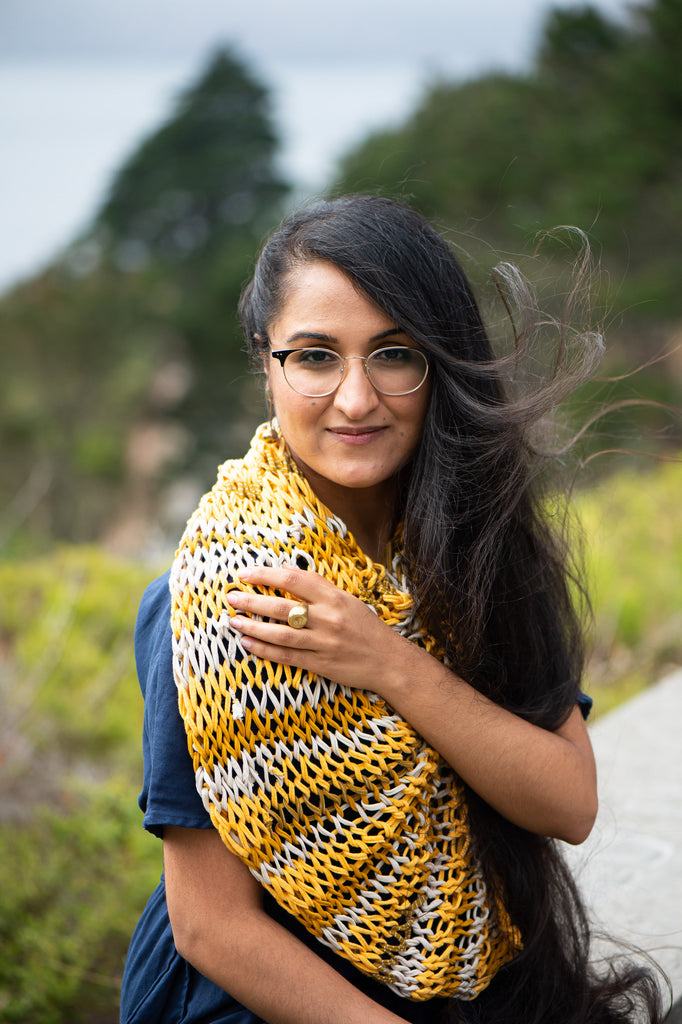 Manpreet Kalra wearing a hand-knit zero waste poncho in mustard