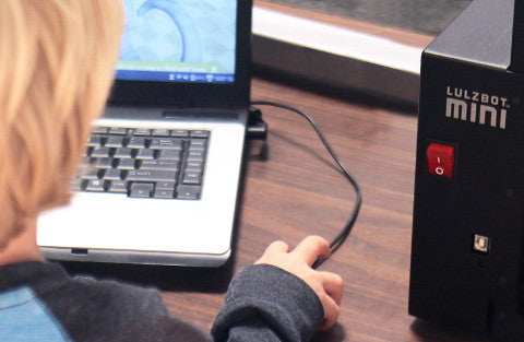 Student in front of Lulzbot Mini 3D printer