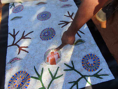 Katie Kemarre points to symbols in bush tucker painting