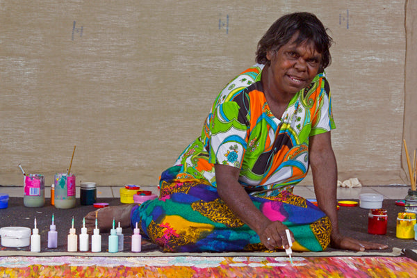 Lucky Morton Kngwarreye using bottles to paint 