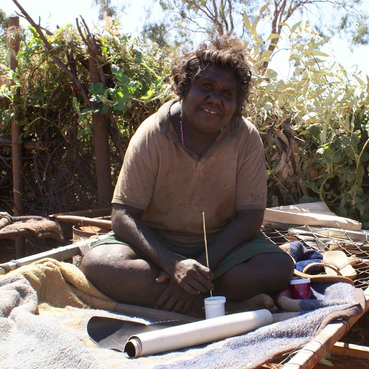 Elizabeth Mpetyane painting on a bed frame