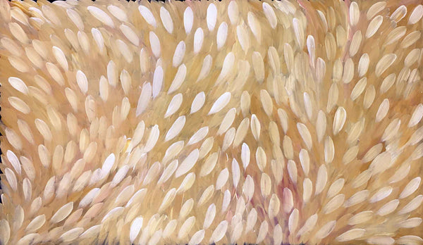 An 'big leaf' painting by Gloria Petyarre in warm earthy yellows and a layer of white leaves over the top.