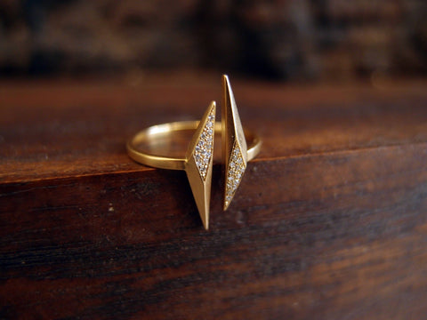 A gold ring featuring diamonds, made by Marion Cage and customizable to your liking.