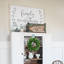 Family Is Everything personalized print framed on top of a dining room hutch