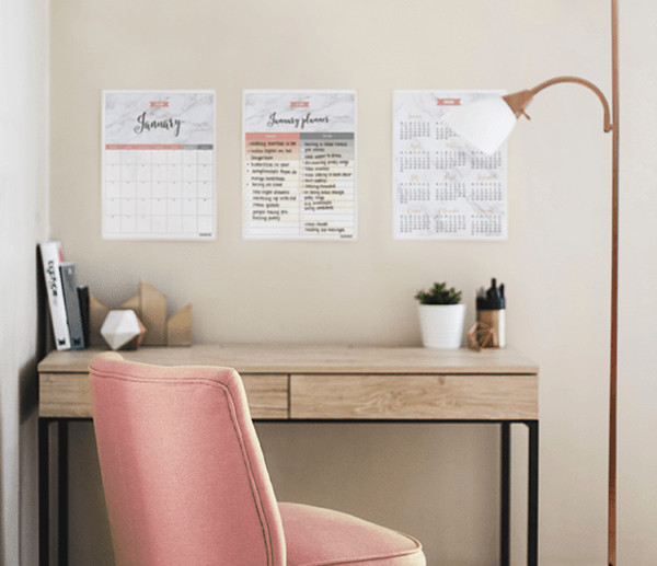 Gorgeous blush boho home office workspace with a free 2018 printable calendar in marble and blush displayed on the wall above the desk
