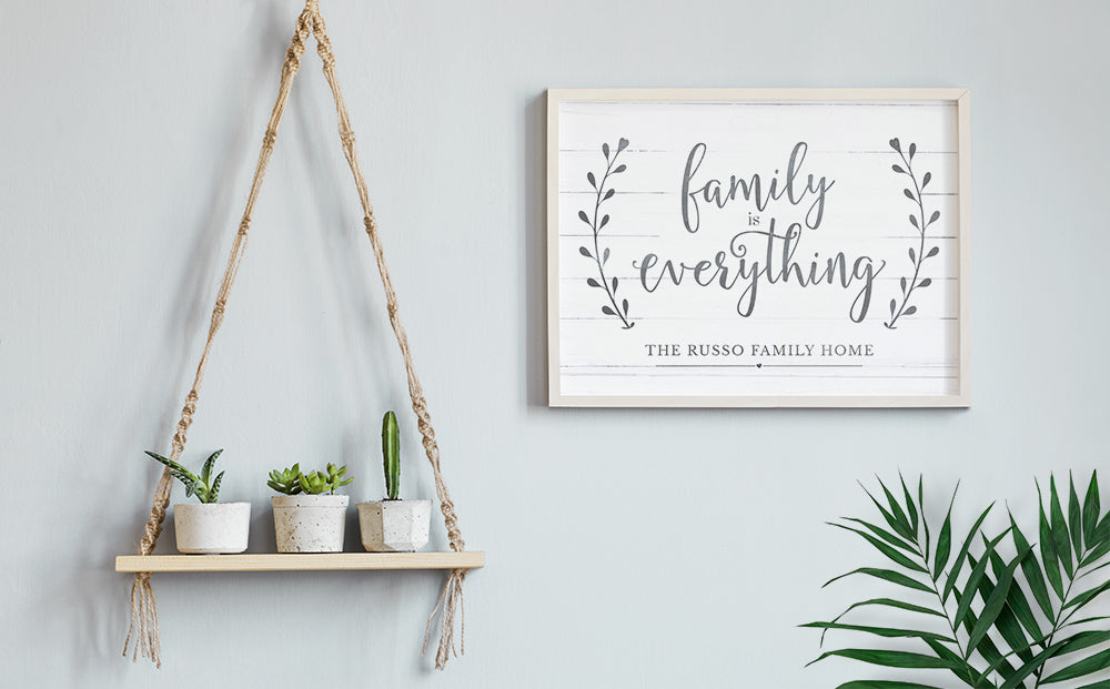 modern boho decor home with a framed Family Is Everything personalized print hanging on the wall