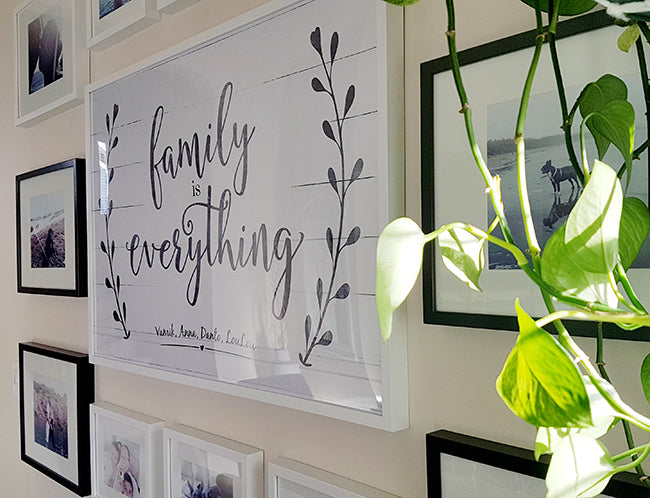 Close up of a gallery wall with family photos in a farmhouse dining room.