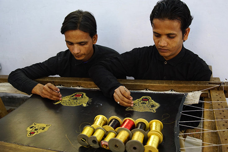 Complete Unknown Artisans embroidering by hand.