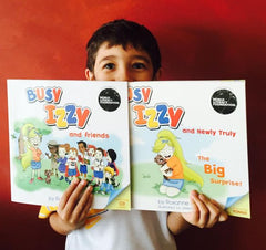 Excited boy reading Busy Izzy's first book