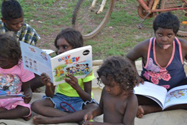Indigenous Australian children reading Busy Izzy and Friends books.