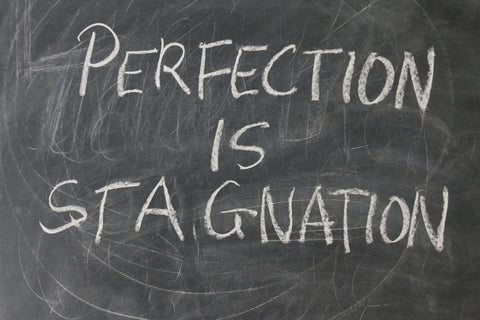 Perfection is Stagnation Written On Chalk Board