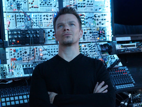 Attila Hanak in front of his modular synths in his studio
