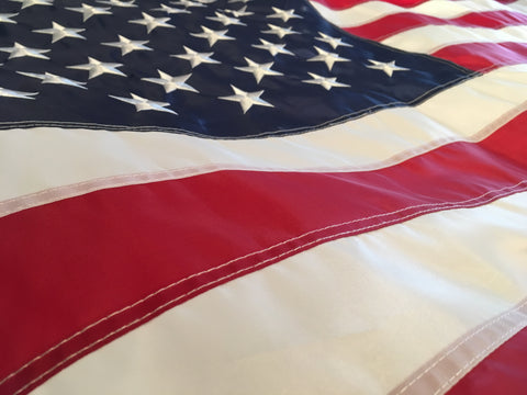 Close up of American Flag with sewn stripes and embroidered stars