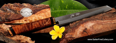 Kiritsuke slicing knife with 'combat chef' style handle featuring rare super curly koa wood and brass accents