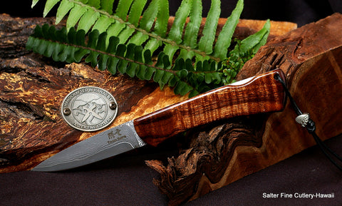 Folding lockback pocket knife with 3" hand-forged blade, curly koa wood handle without bolster, and titanium liners