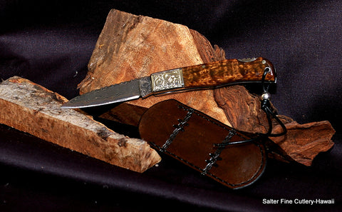 Kanona 2.5" pocket knife with stainless damascus blade, backstrap filework and embossed bolster. Sterling silver decorative bead.