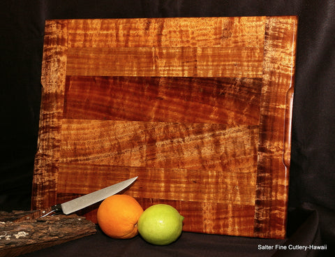 Small koa wood cutting board with utility knife