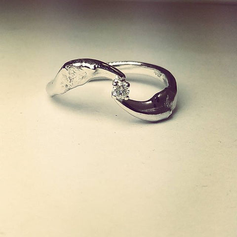 Dog tooth engagement ring