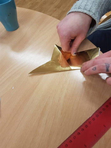 making a 3D star by folding each arm of the star to its opposite