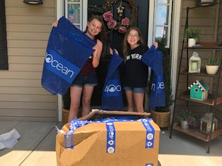 Olivia and Julia proudly display their first shipment of 4ocean Cleanup Totes