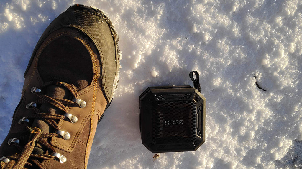 Aqua Mini Bluetooth speaker bearing the natural elements and playing songs 