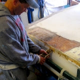 Greg removing screws during the Sandra boat restoration project.