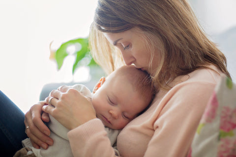 baby and mum snuggling