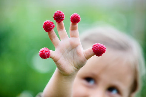 girl eating raspberries