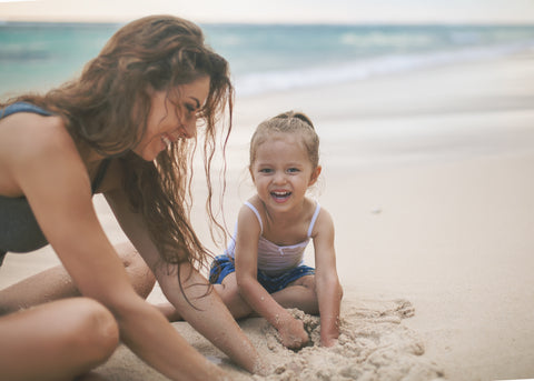 mum and girl in the beach
