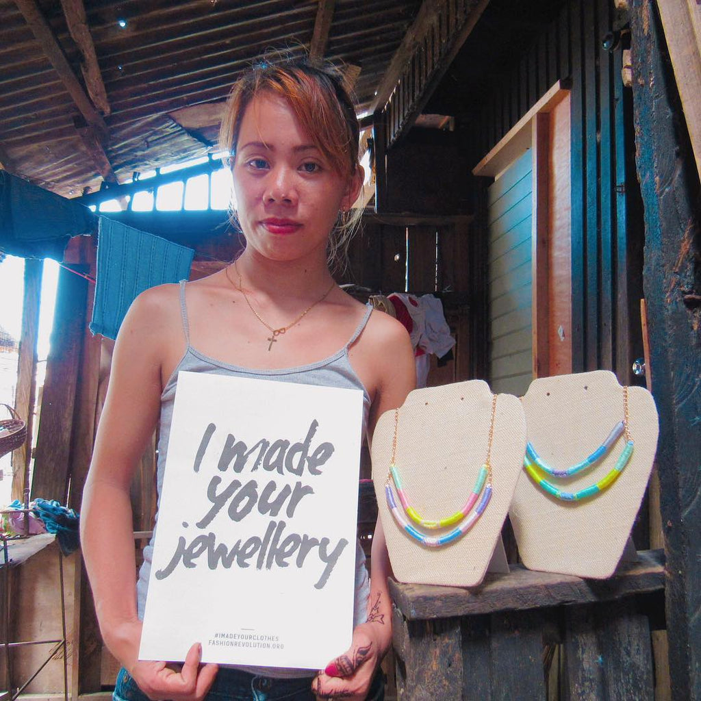 Jennifer, one of the artisans behind our Olivia & Diego jewellery, holds up a sign in support of Fashion Revolution Week