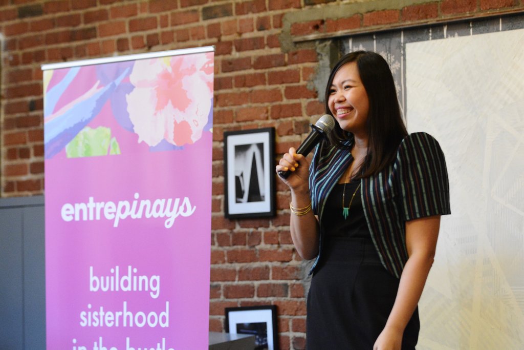 Gelaine Santiago, social entrepreneur and co-founder of Cambio & Co., wears a terno from ANTHILL Fabric Gallery as she speaks on stage at the Pinayista Summit to Filipina entrepreneurs in San Francisco at Covo 