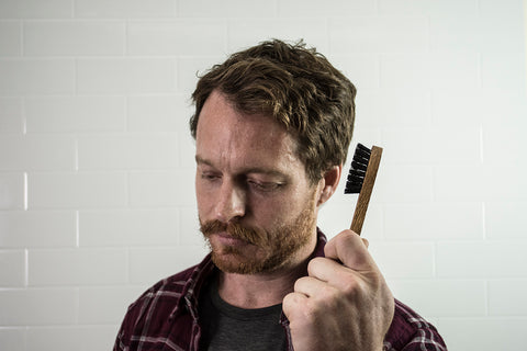 moustache man holding moustache brush