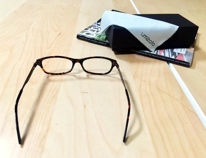 Tortoise prescription glasses began from Umizato sitting on a flat surface