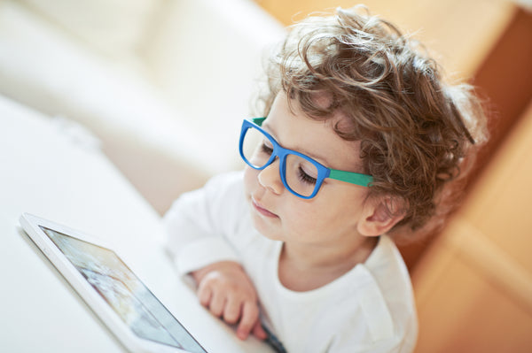 child wearing blue light blocking glasses