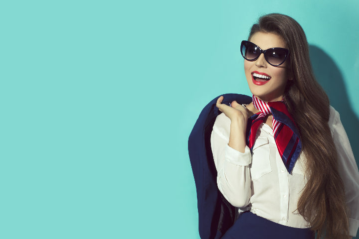 Flight attendant wearing black cat-eyed sunglasses frame