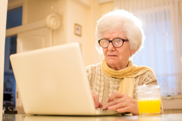 old woman on computer with her outdated and out-of-fashion prescription glasses