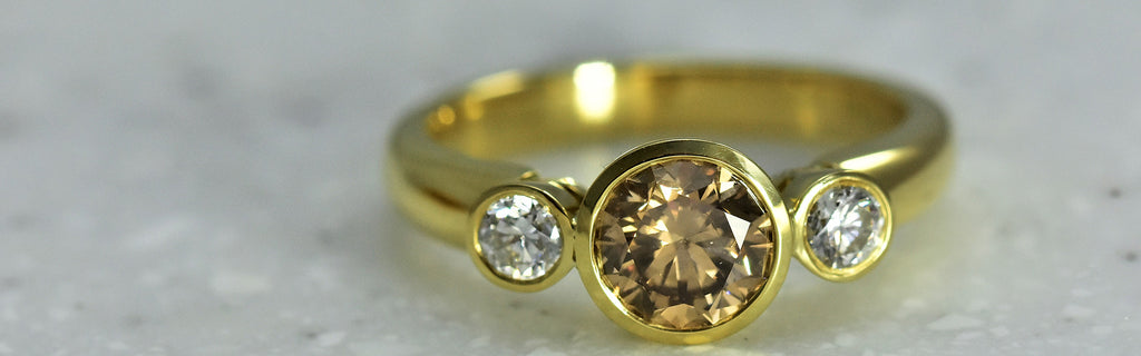 Champagne diamond with side diamonds ring in yellow gold