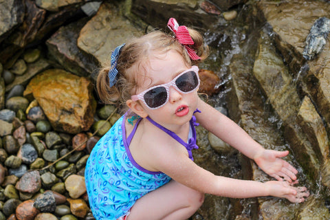 Little girl enjoys playing under the sun 