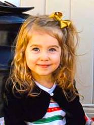 little girl smiling in her holiday dress