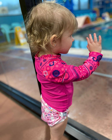 Baby girl wearing reusable swim diaper