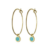 Delicate gold hoop dot earrings in emerald