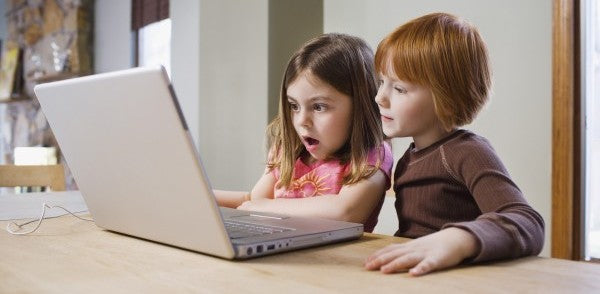 kids looking at laptop blue blocking glasses