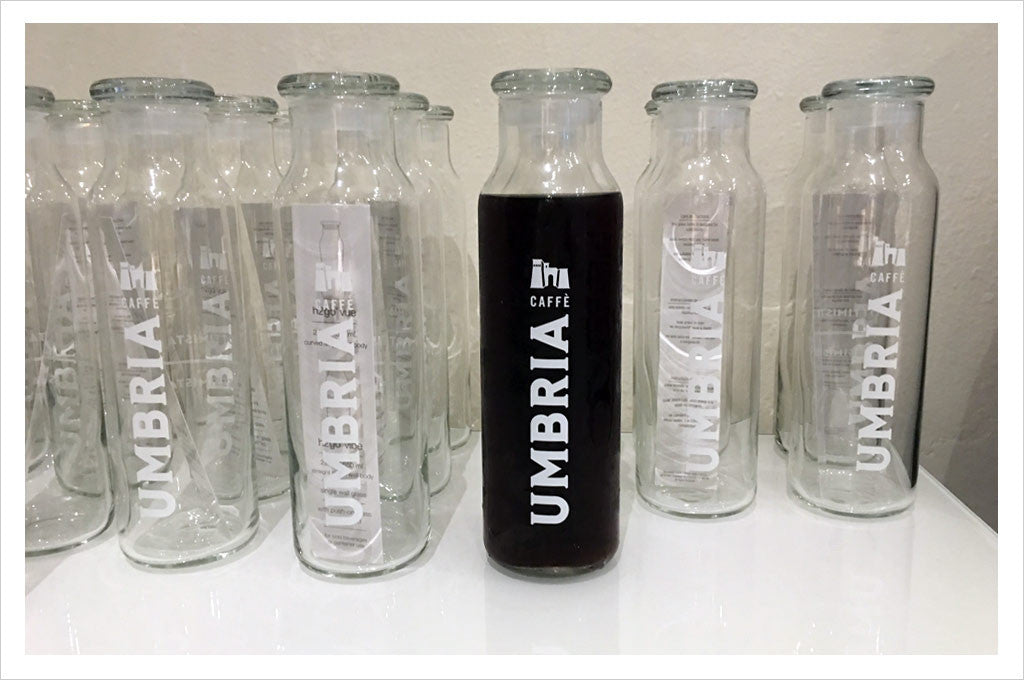 Caffe Umbria - Logo water bottle filled with cold brew