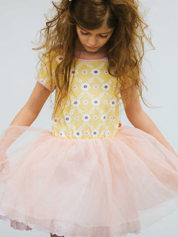 Girl in a yellow flower dress with a pink tulle skirt