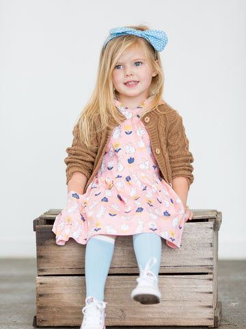 Girl in pink bunny dress and brown cardigan
