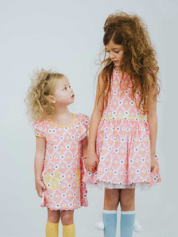 Two girls in pink flower dresses