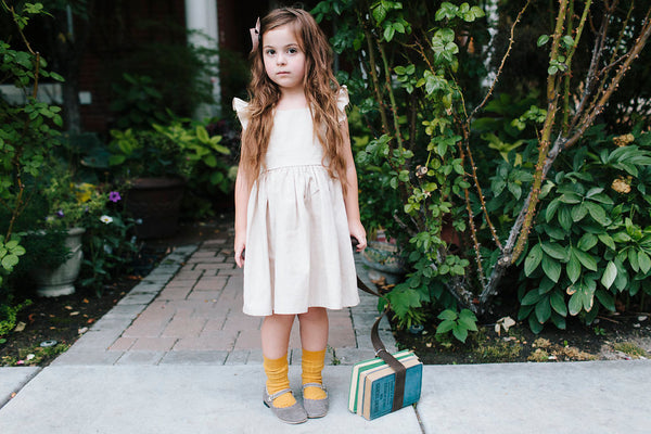 Wren & James linen pinafore in Natural pairs well with goldenrod for autumn.