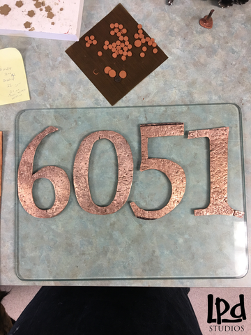 LPDstudios Blog: Custom Corner - Copper Metal Address Plaque. Once the numbers were distressed and the edges were smoothed, I fired them in my special kiln designed for metal clay. The high heat of the kiln burned off the binder in the metal clay and the particles fused together to create solid copper metal pieces. The color drastically changed from a matte terracotta to a high luster copper.  