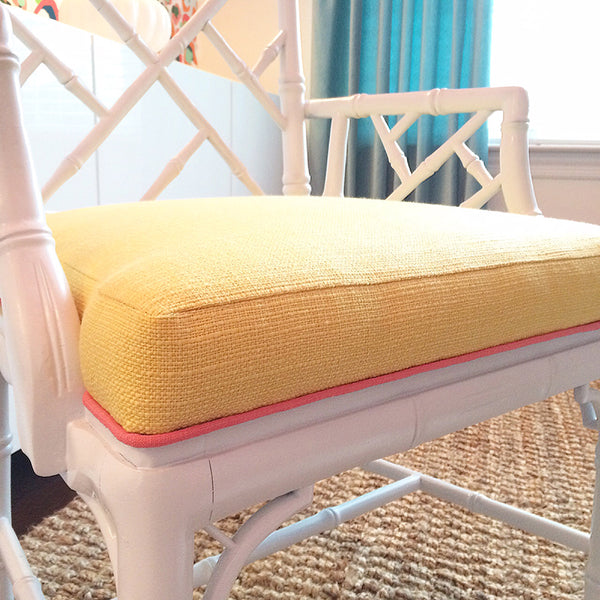 Yellow linen seat cushion with pink piping