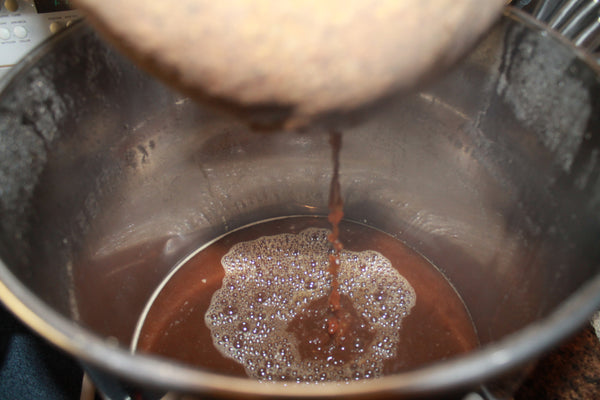 steeping grains dripping into brew pot